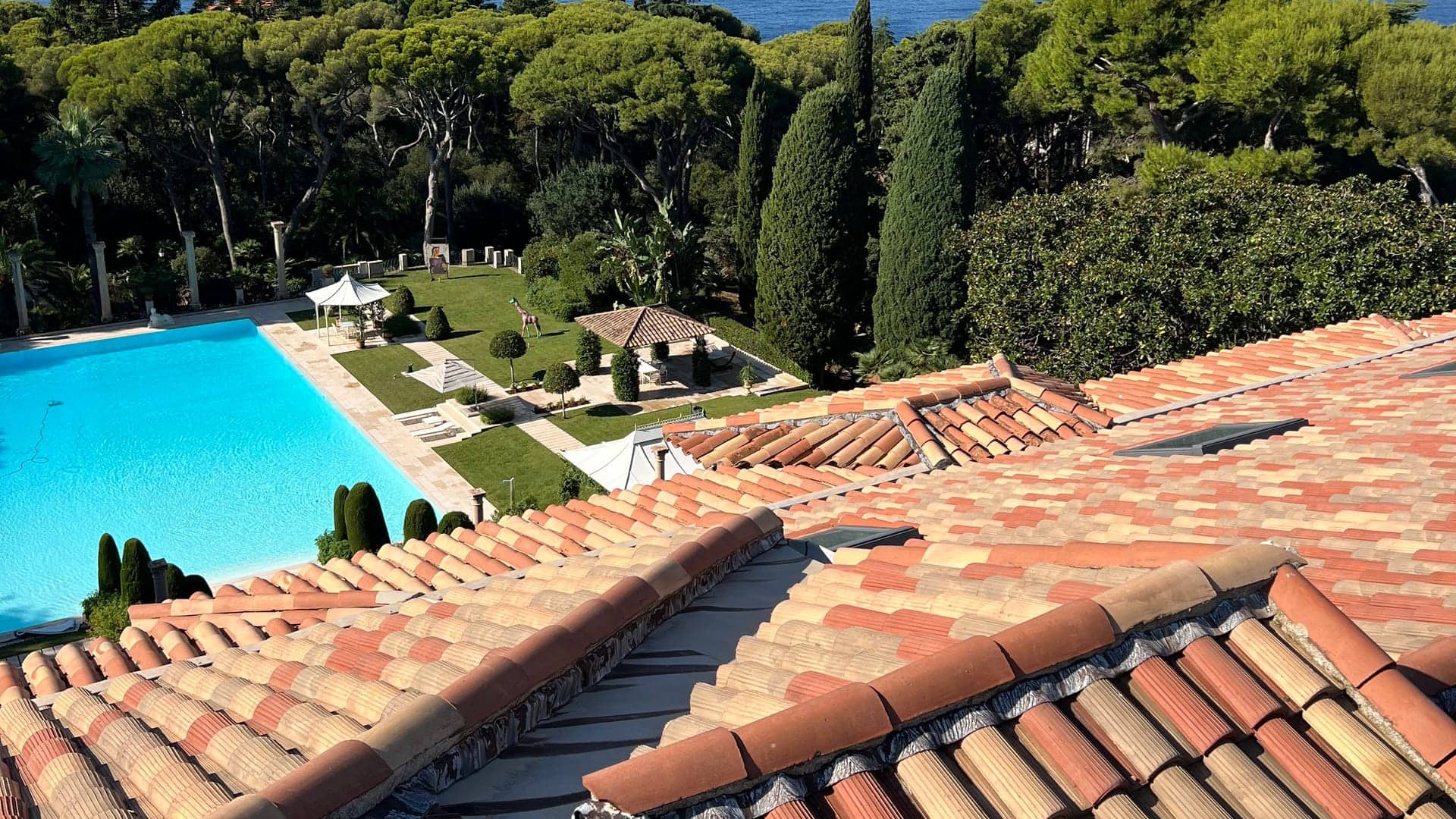 Toiture en tuiles canal d'une villa au-dessus de son parc et de sa piscine, chantier de Artisan Louis Duval